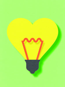 A yellow heart-shaped lightbulb with a red filament.
