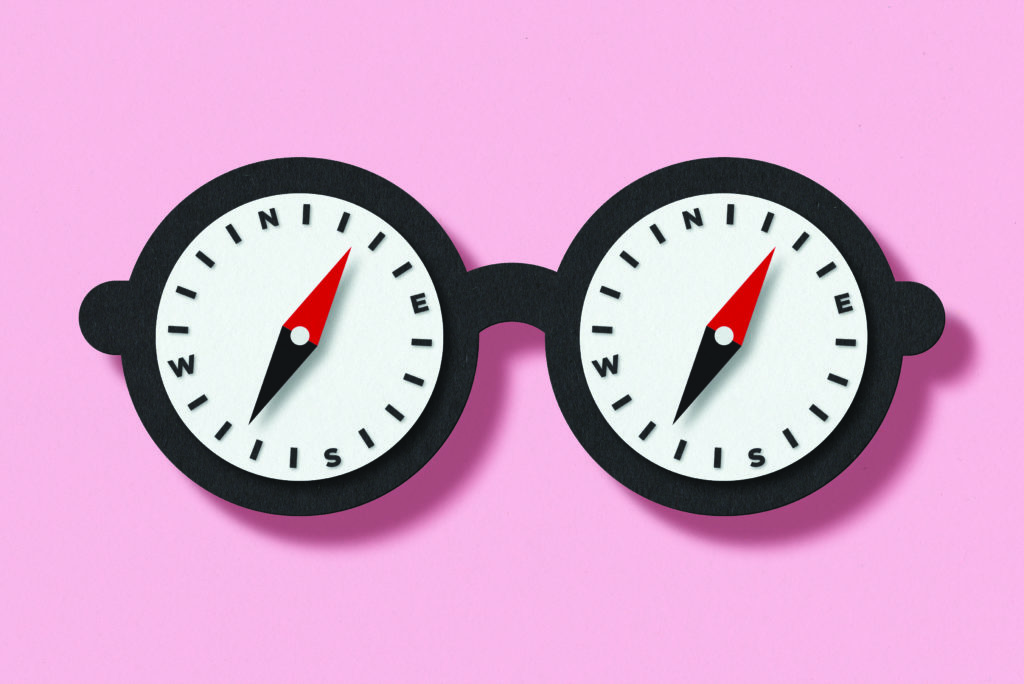 Two compass instruments on a pink background.