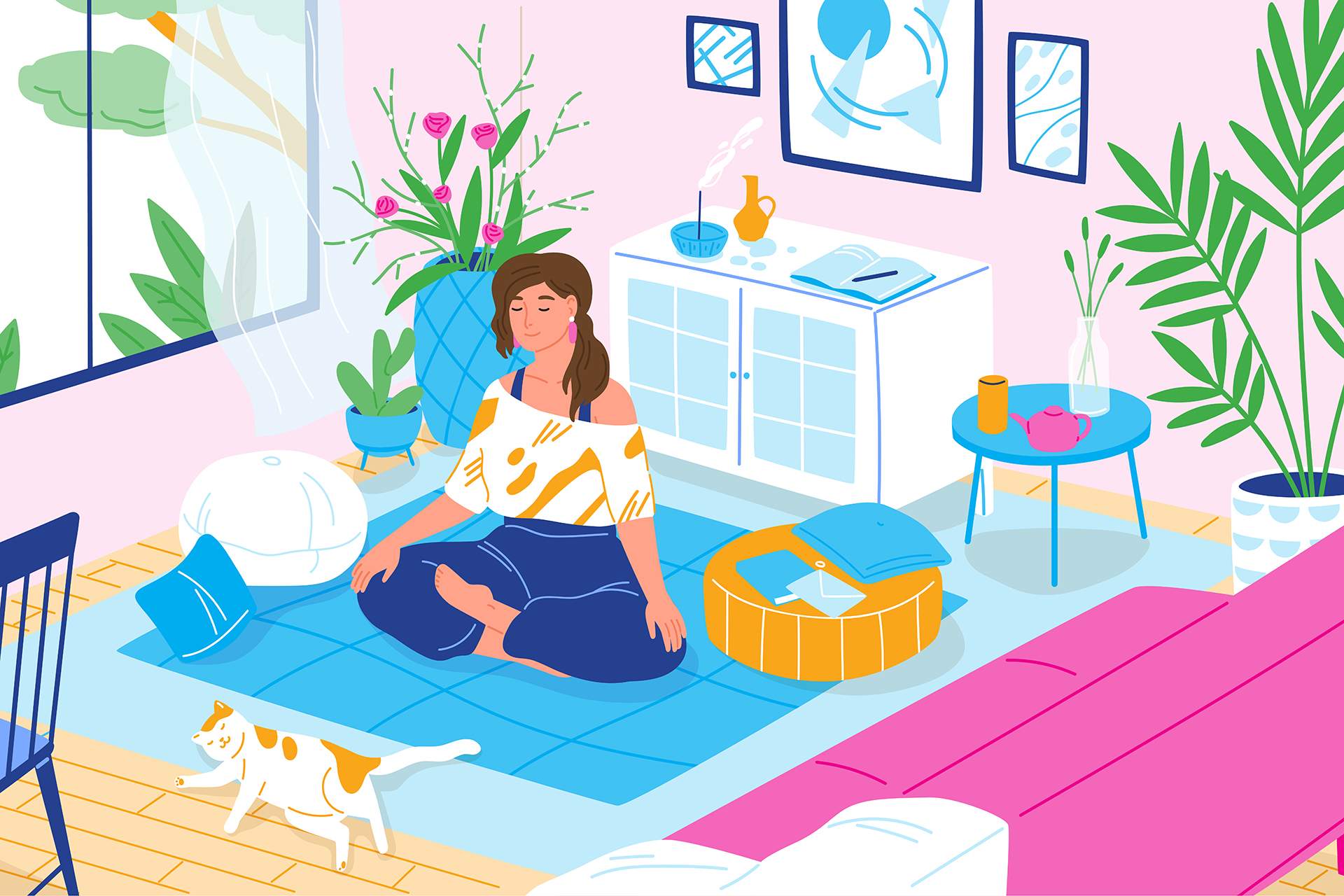 A woman sits on a blue mat doing yoga in a bright, plant-filled home workspace.