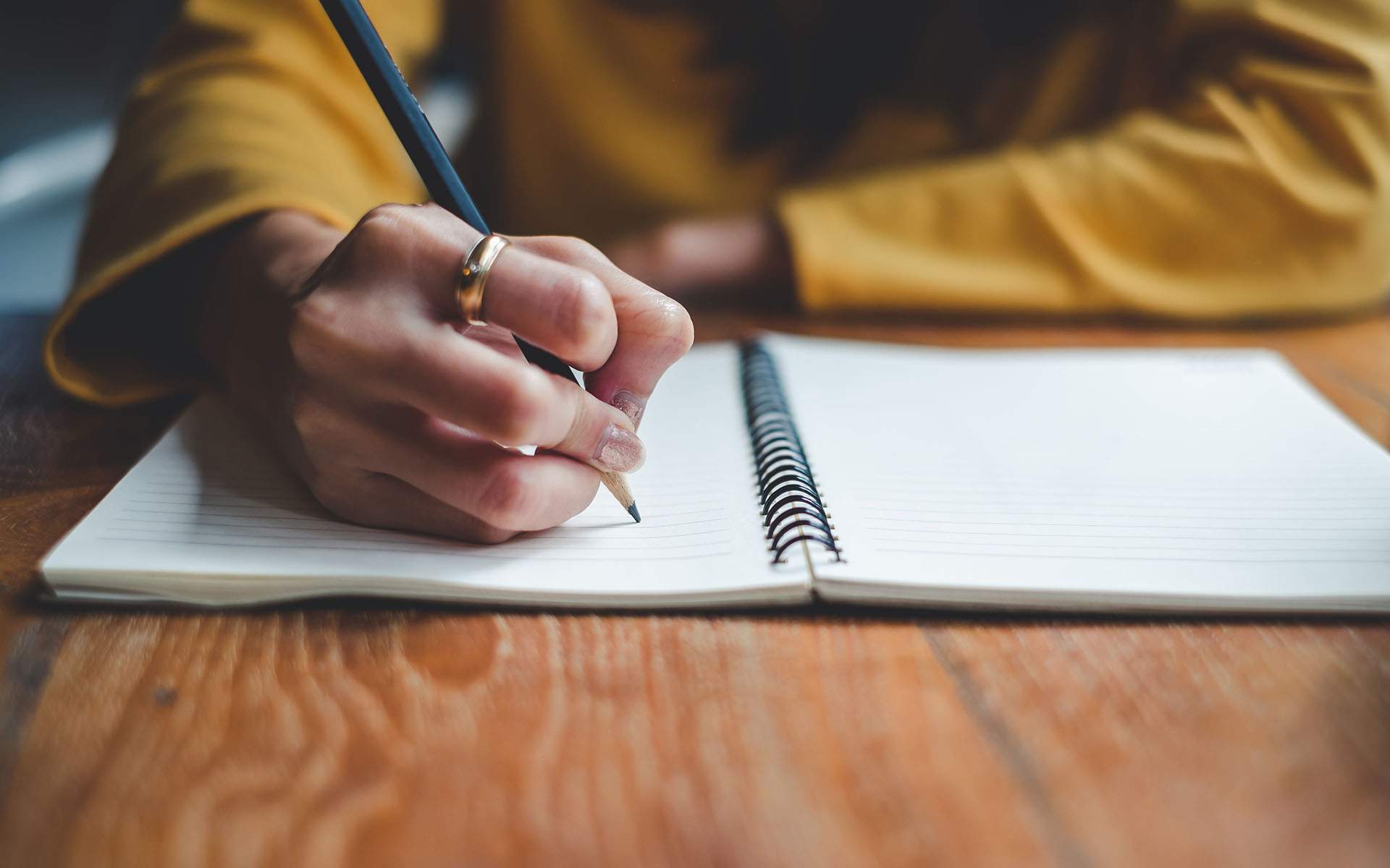 Getting Started with Mindful Writing - Image of a close up hand writing in notebook