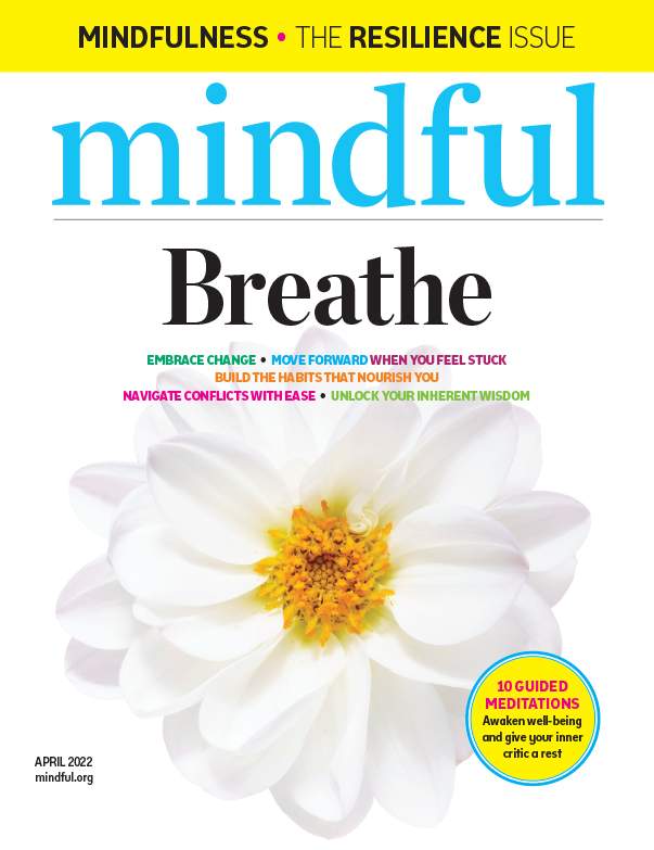 A cover of Mindful magazine's April 2022 "Breathe" issue featuring a white flower with a yellow center.