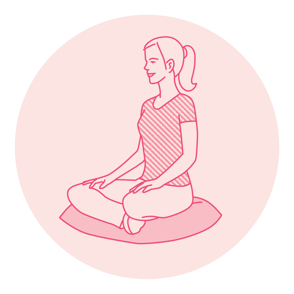 A woman sitting cross-legged in a meditation pose.